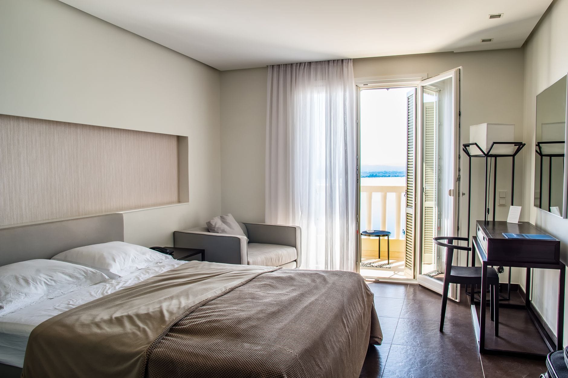 Elegant hotel room with sea view balcony, a key package holiday inclusion