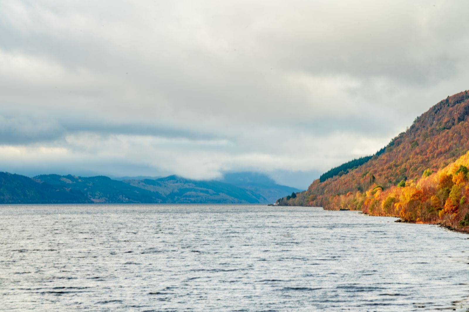 Loch Ness in autumn colour, the best-known stop on a Highlands day tour from Edinburgh