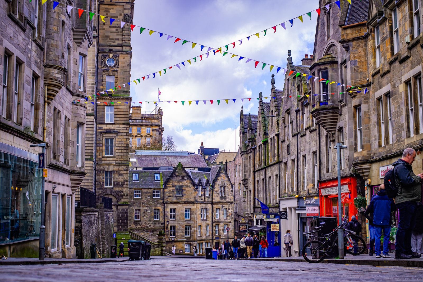 Victoria Street in Edinburgh's Old Town, part of the historic Royal Mile with bunting overhead