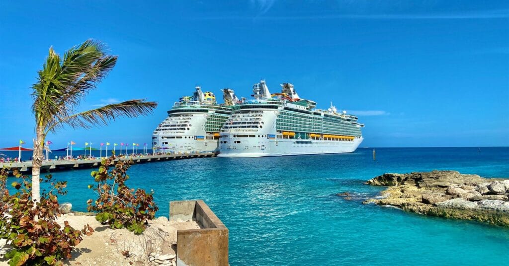 Large cruise liners docked beside bright blue water