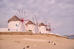 Greece budget travel, traditional windmills overlooking Mykonos Town and the Aegean Sea
