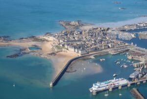 Aerial view of Saint-Malo's walled city, beach and harbour, the base for exploring Saint-Malo on a budget