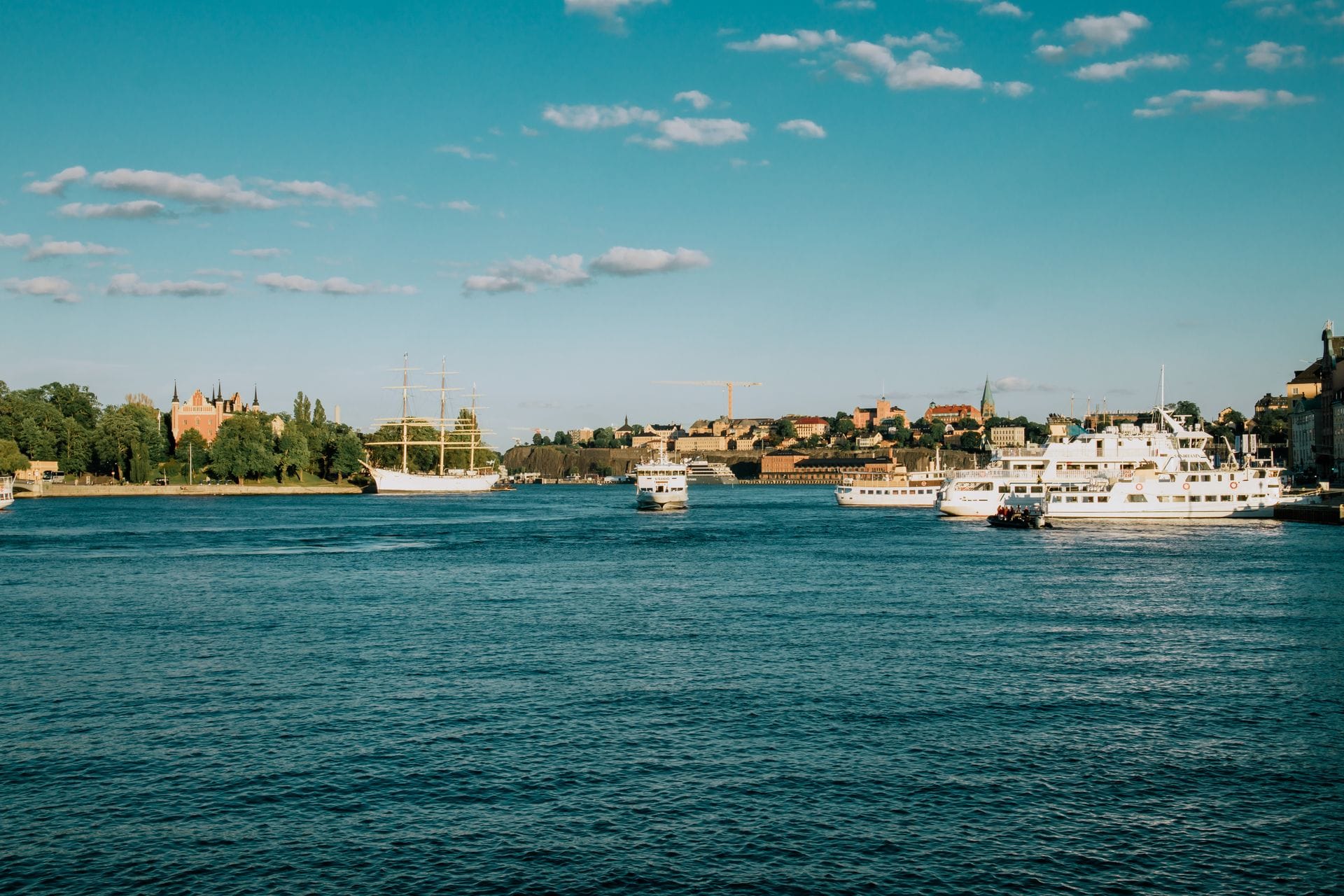 Sunny summer day on the Stockholm waterfront with boats and the city skyline