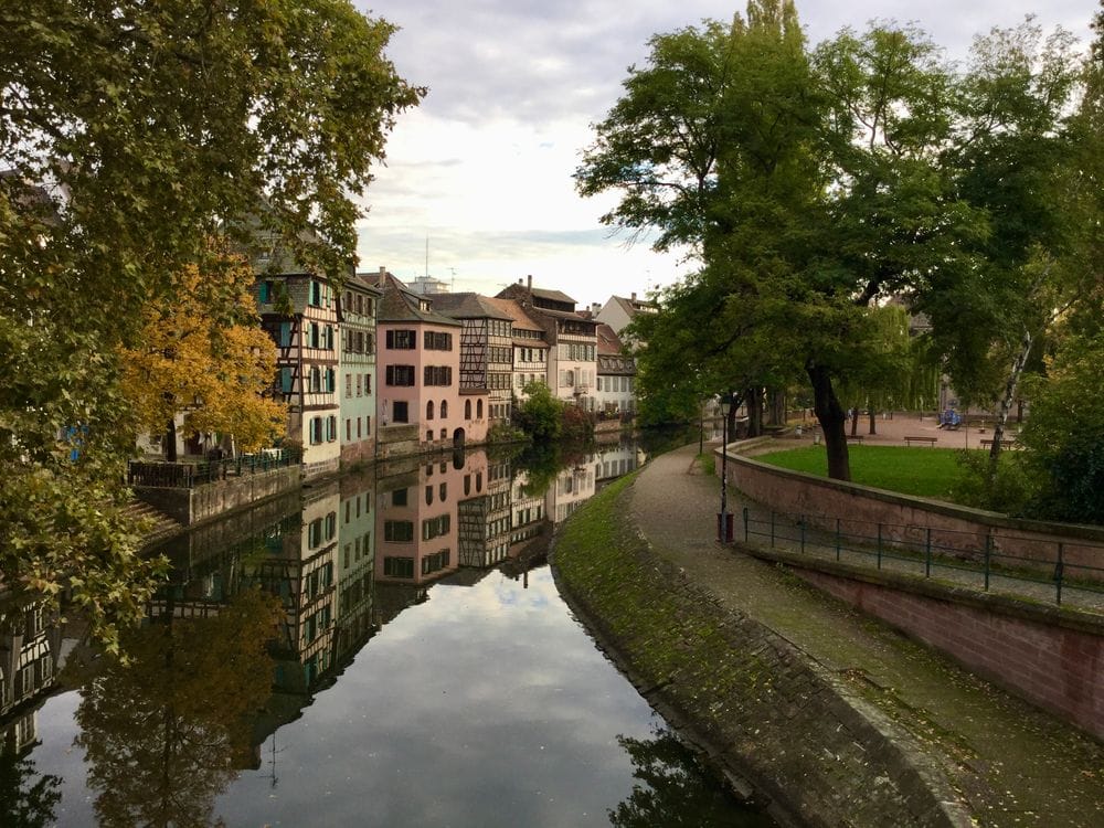 Half-timbered houses reflected in the canal in Petite France, Strasbourg, in autumn