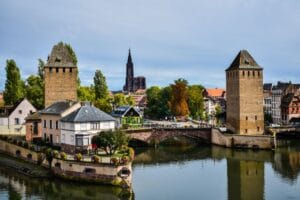 Strasbourg on a budget guide featured image: the Ponts Couverts medieval towers and cathedral spire above Petite France