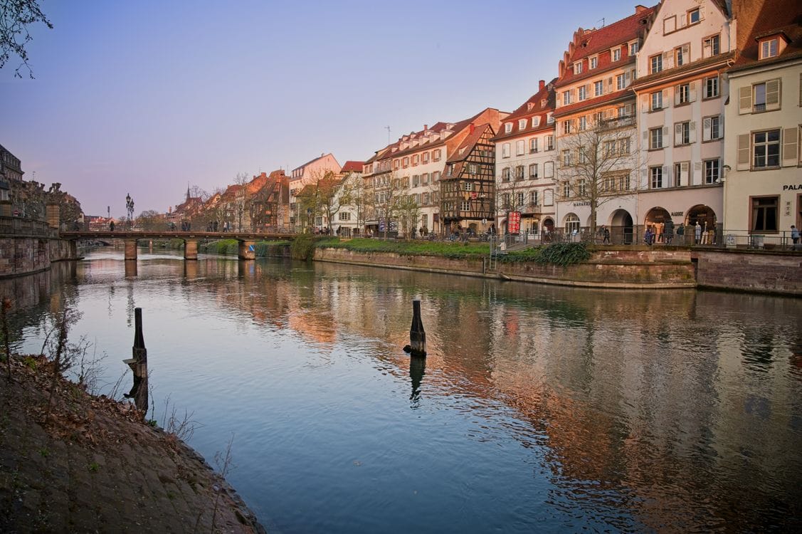 Historic buildings along the Ill riverside in Strasbourg at sunset