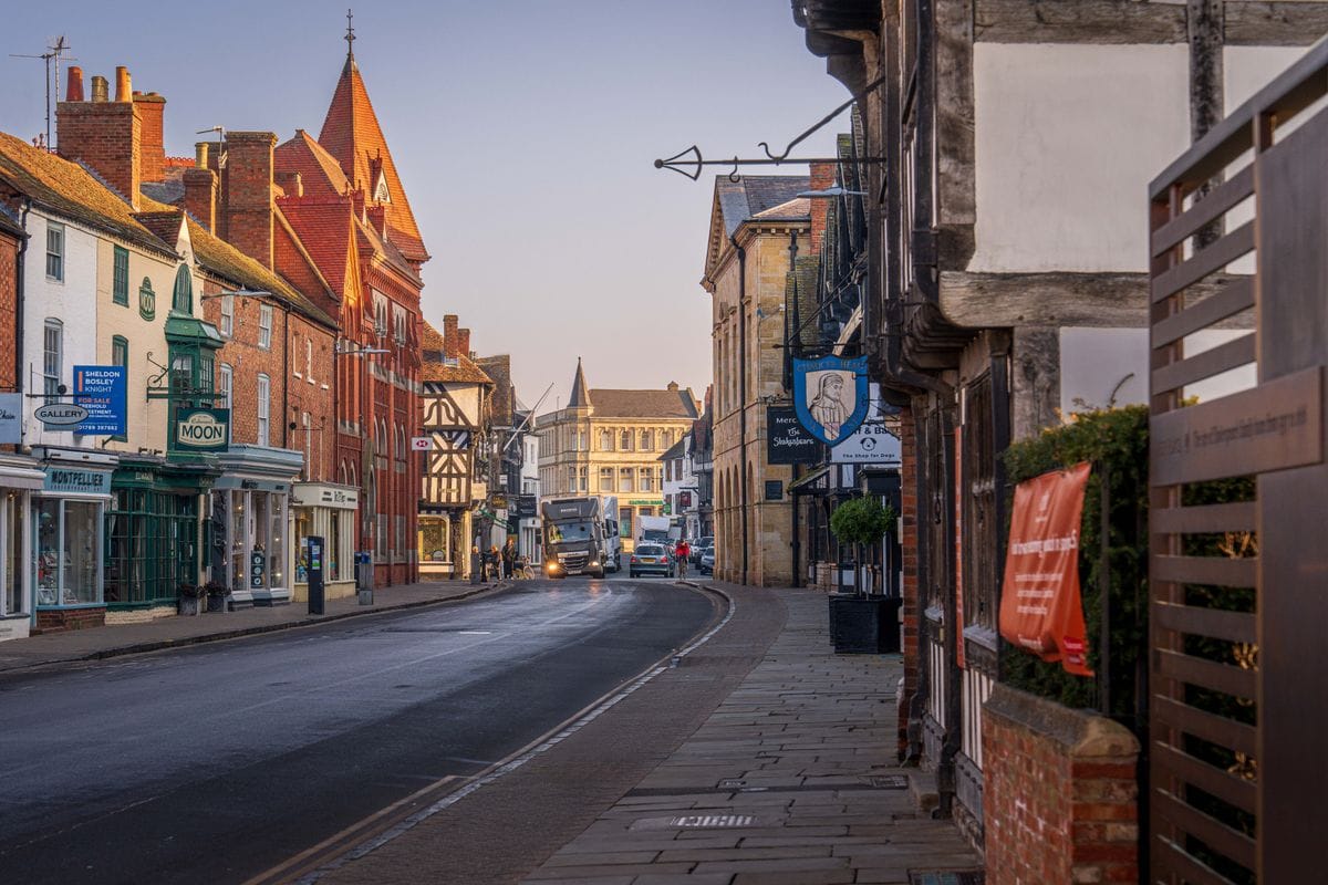 A Tudor-lined street in Stratford-upon-Avon town centre at dusk
