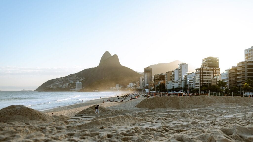 Ipanema Beach in Rio de Janeiro with mountains and city skyline