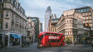 Red London double-decker bus on a city street for the TfL Weekend Hopper deal