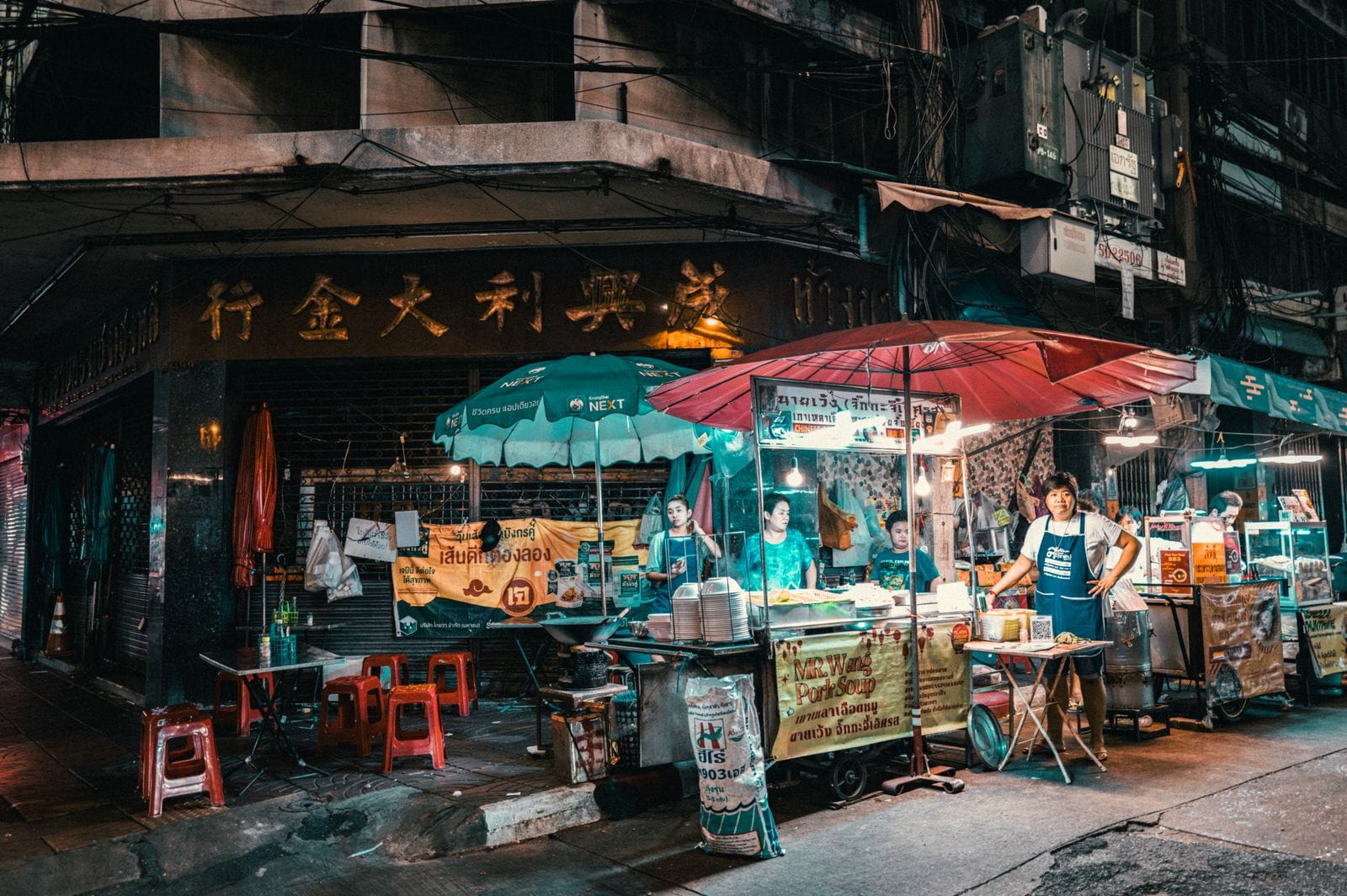 A street food stall lit up at night in Bangkok
