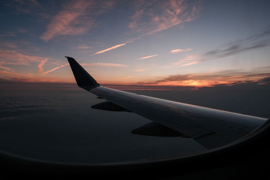 Aircraft wing silhouette at sunset, representing a Transavia sale-period departure