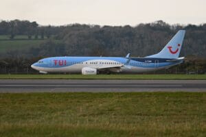 TUI Boeing 737 aircraft taxiing on the runway, best carry-on bag for TUI