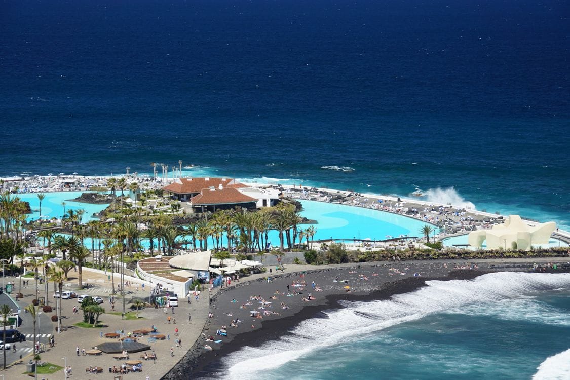 Aerial view of a seafront lido and resort on Tenerife, a popular TUI Holidays destination