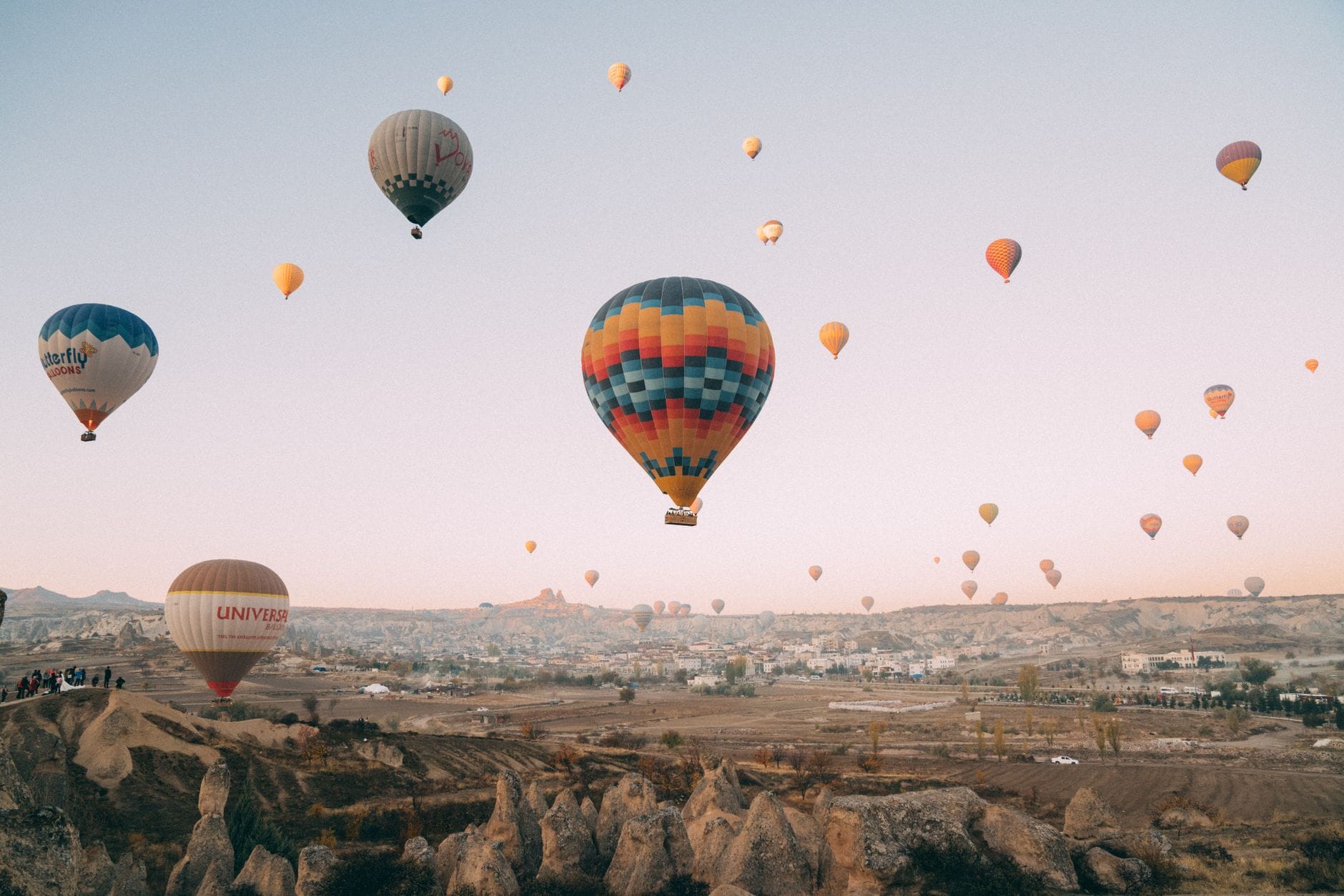 Hot air balloons flying over the rock formations of Cappadocia, Turkey