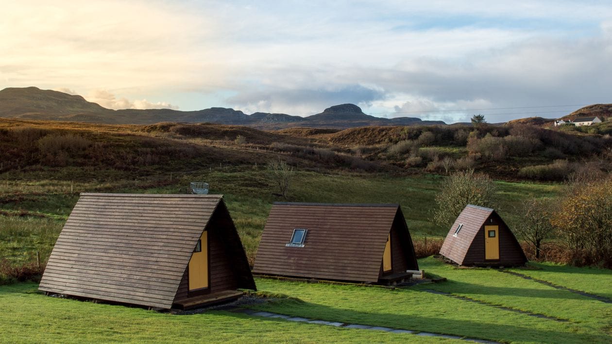 A-frame cabins on a hillside in Scotland
