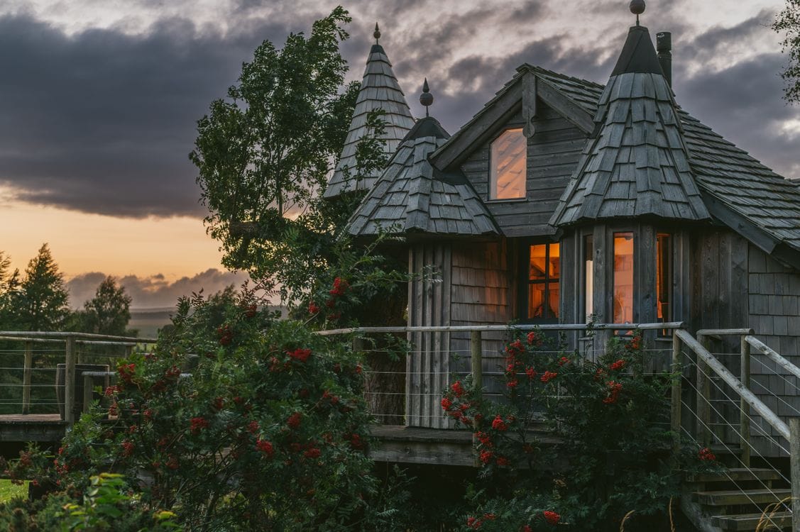 Treehouse cabin at sunset in the Scottish countryside