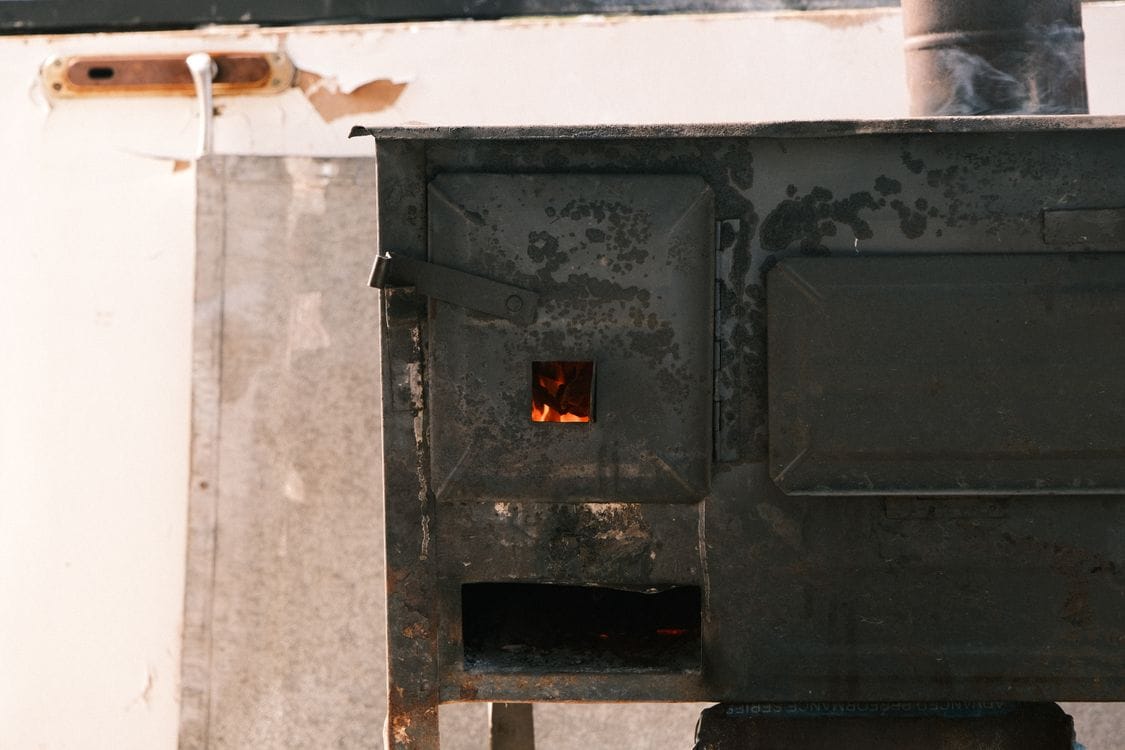 Wood burning stove lit inside a UK glamping hut