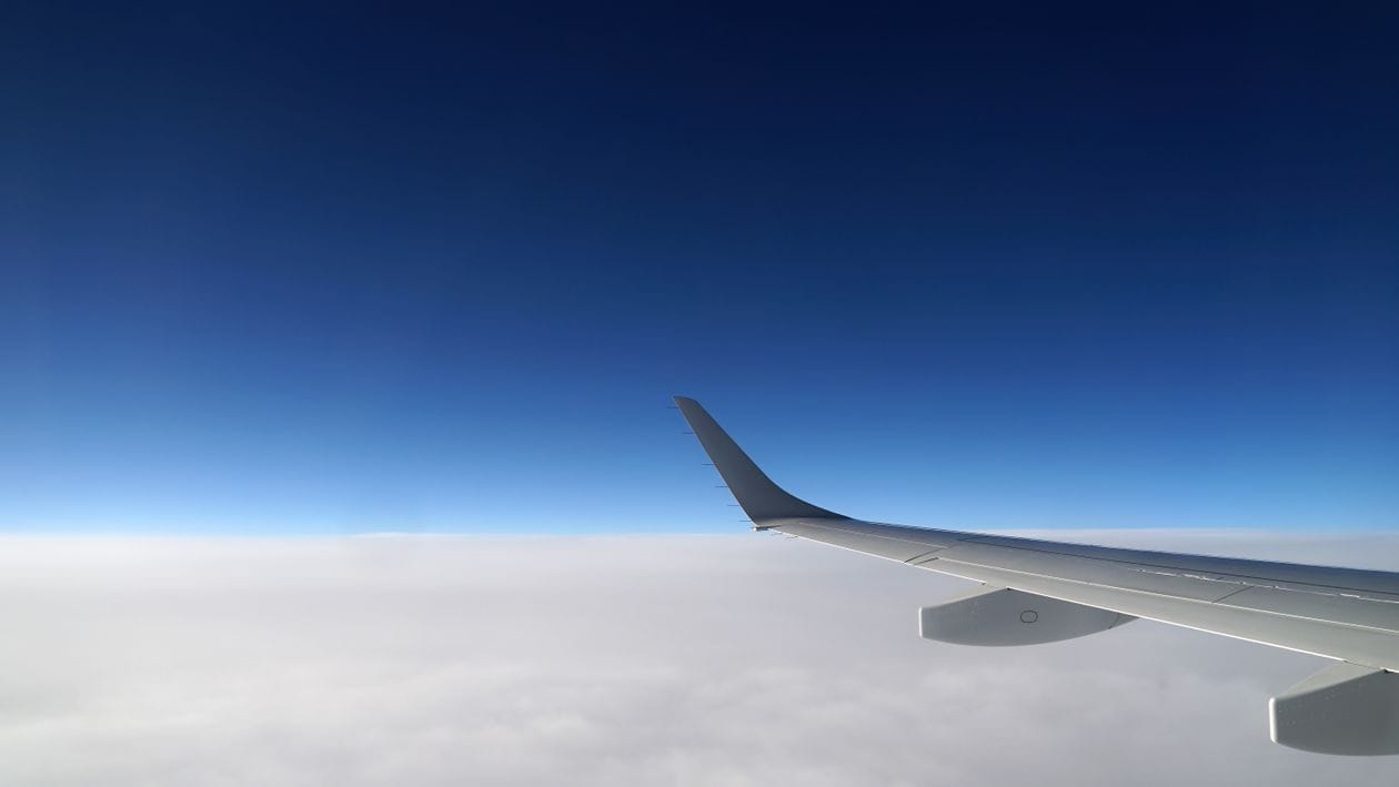 Aircraft wing above the clouds, representing a Vueling route recently opened for booking