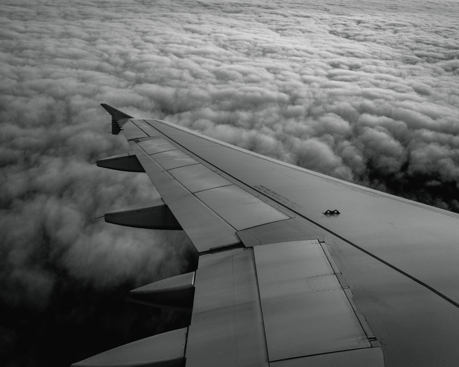 Aircraft wing above the clouds, representing a Vueling sale-period departure