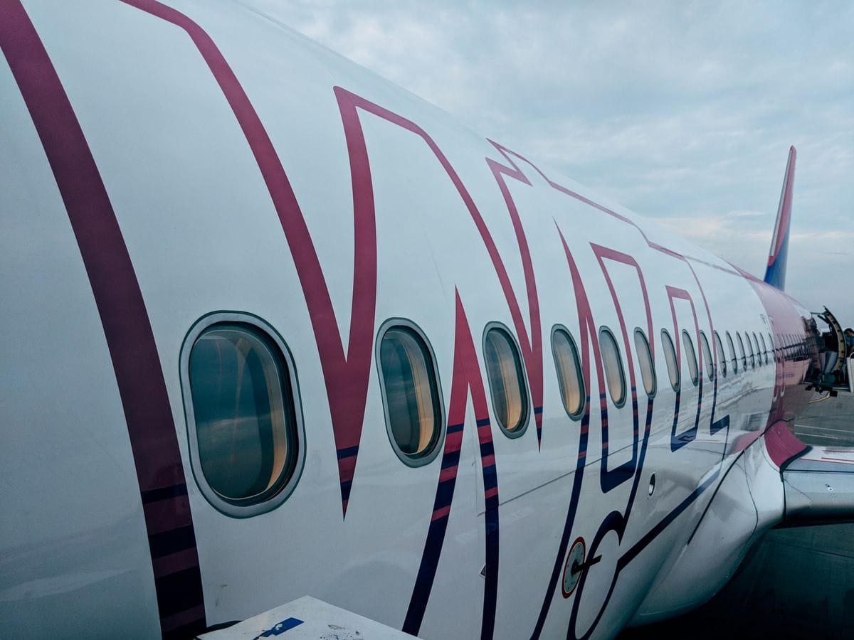 Close-up of a Wizz Air Airbus fuselage showing the airline's magenta livery