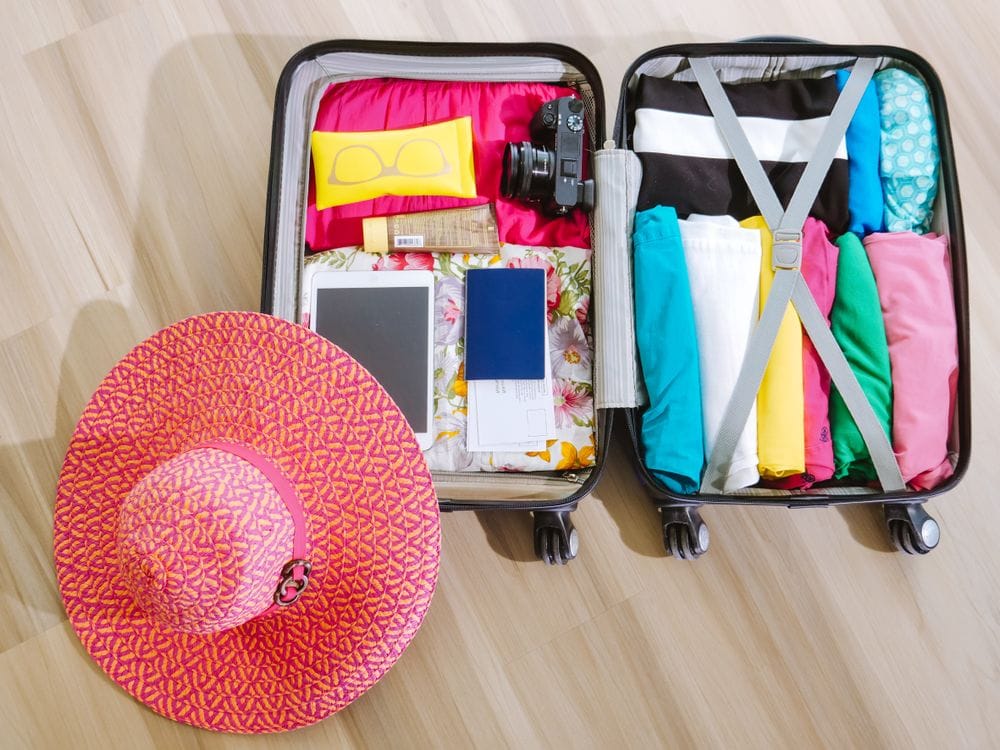A packed suitcase with holiday essentials laid out before departure