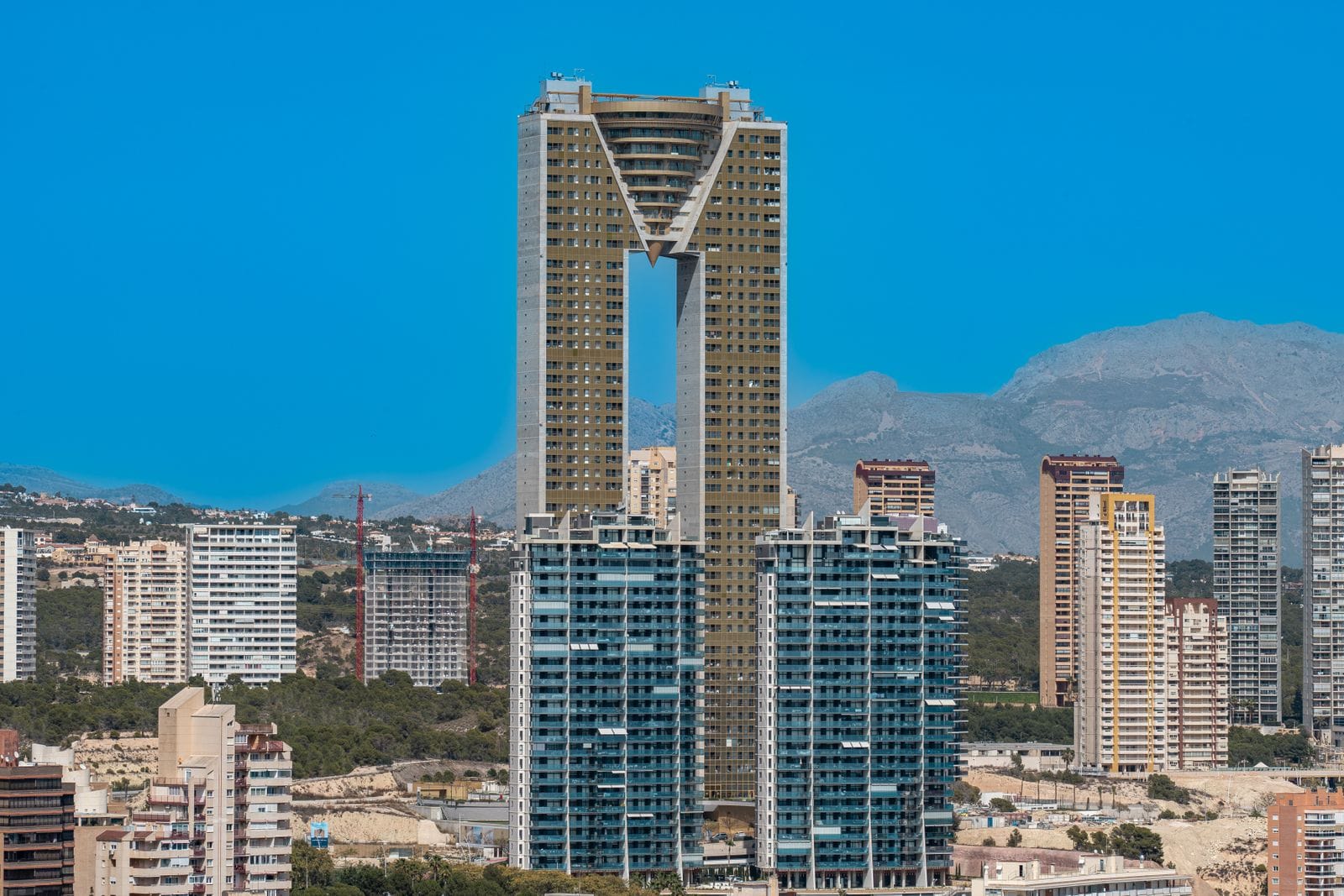 Benidorm's Intempo tower, a twin-pillared skyscraper joined at the top, rising above the surrounding apartment blocks