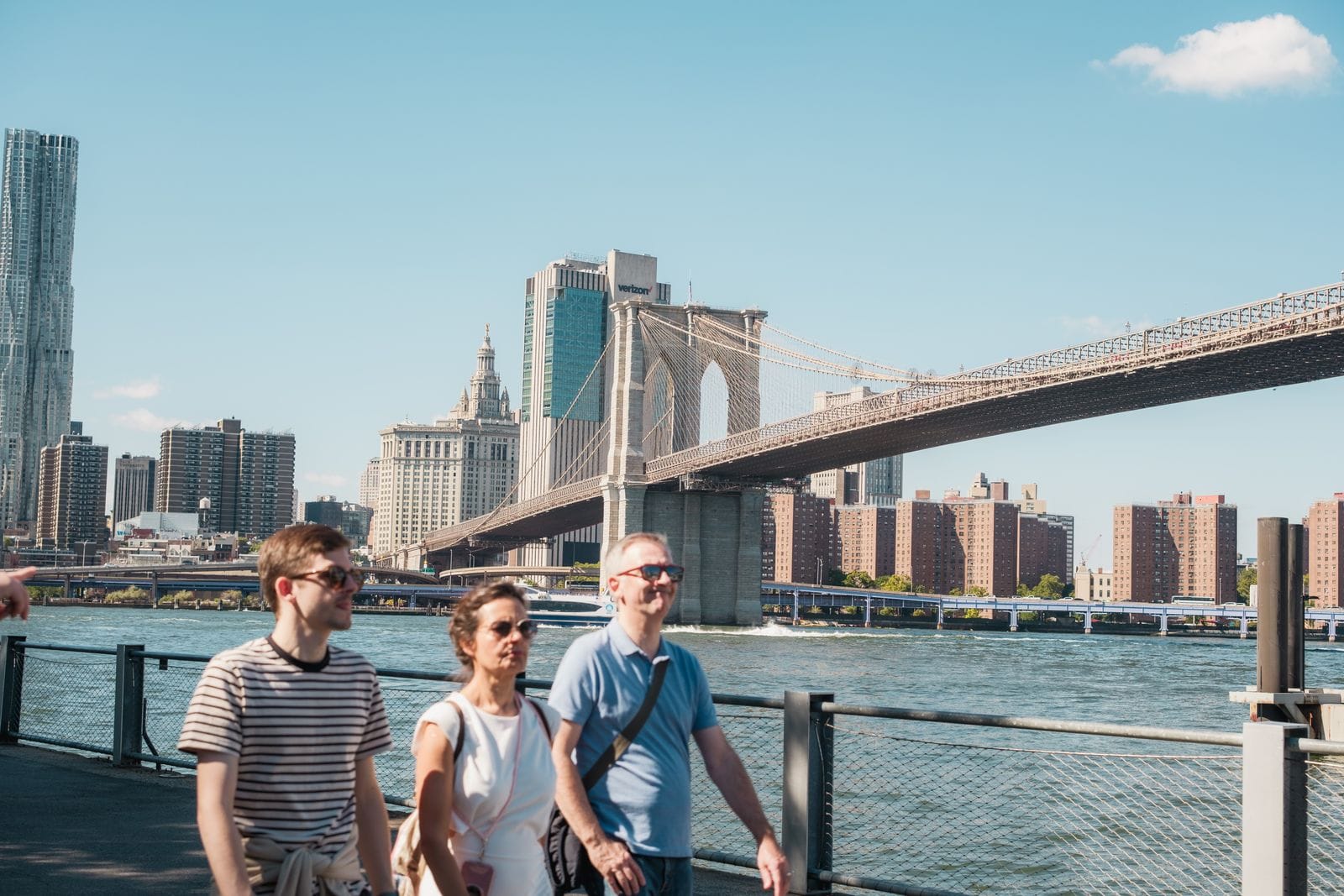 Visitors walking the pedestrian path across Brooklyn Bridge