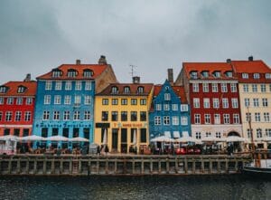 Is Copenhagen expensive: Nyhavn's colourful 17th-century harbourfront houses on an overcast day