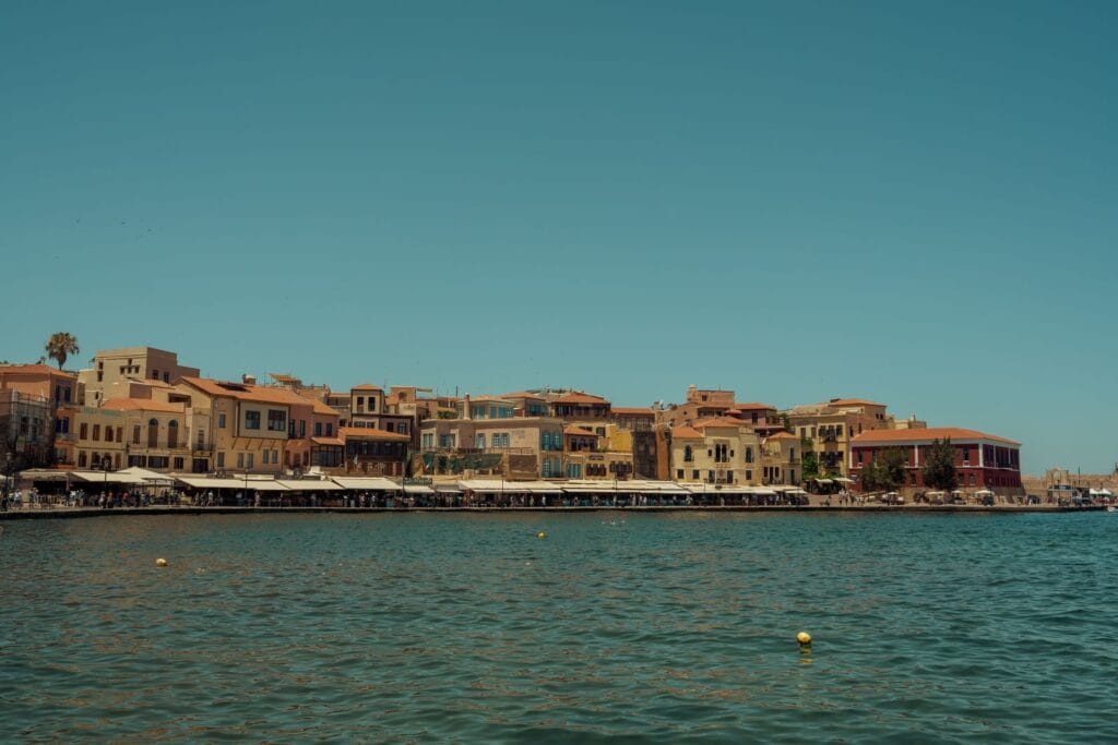 Is Crete expensive: the waterfront of Chania Old Town and its Venetian harbour under a clear blue sky