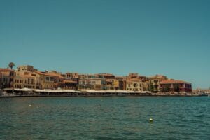 Is Crete expensive: the waterfront of Chania Old Town and its Venetian harbour under a clear blue sky
