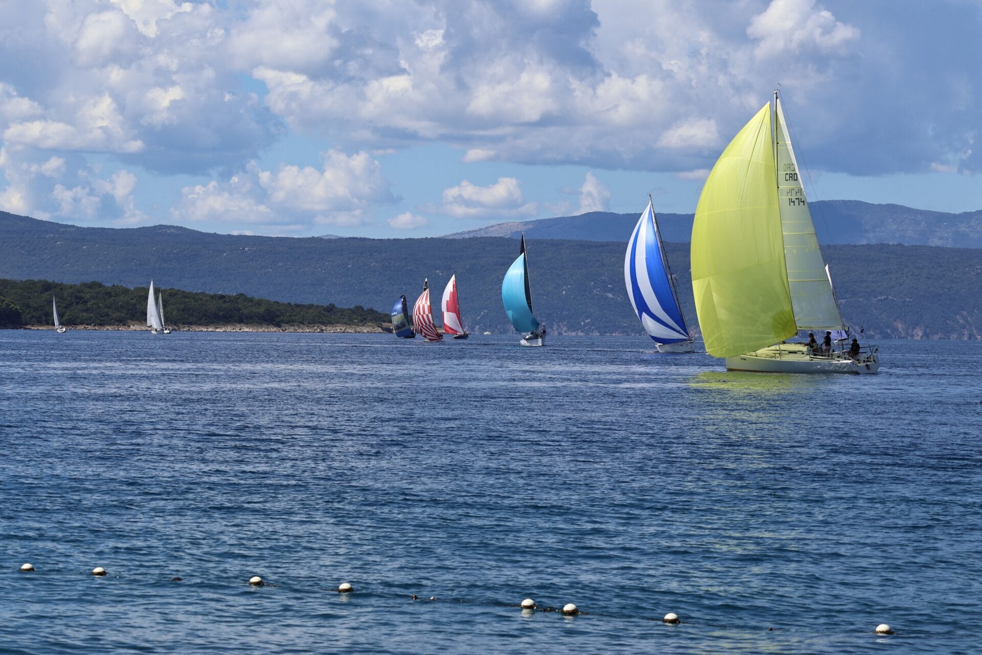 Colourful sailing boats racing, similar to Dartmouth Royal Regatta
