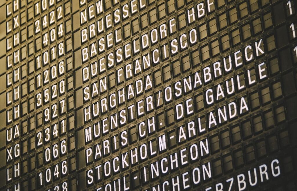 How much compensation can you claim for a delayed or cancelled flight. An airport departure board showing international destinations