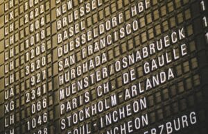 How much compensation can you claim for a delayed or cancelled flight. An airport departure board showing international destinations