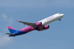 Is Wizz Air travel insurance worth it? A Wizz Air Airbus A321 climbing into a blue sky after departure
