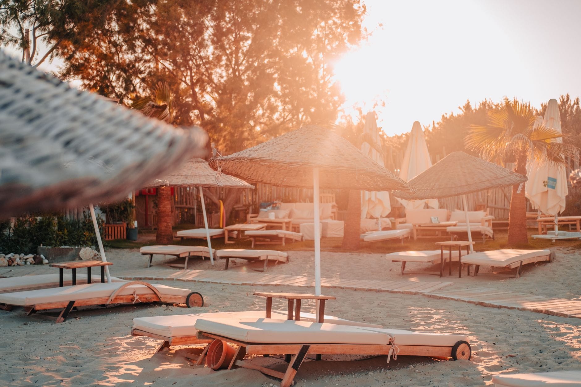 Sunbeds and umbrellas at a Marbella-style beach club at sunset