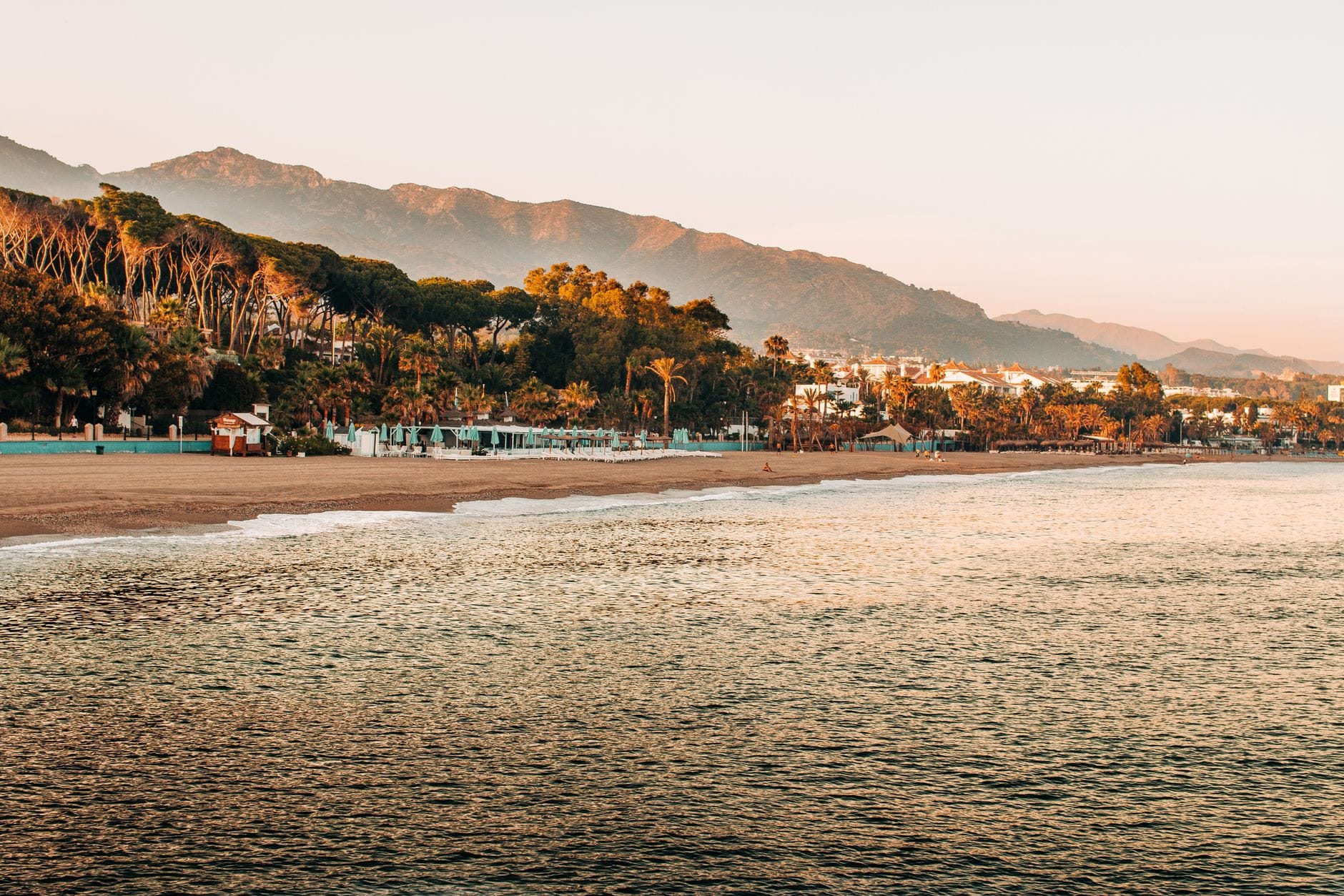 Marbella's beachfront at sunrise with the Sierra Blanca mountains behind