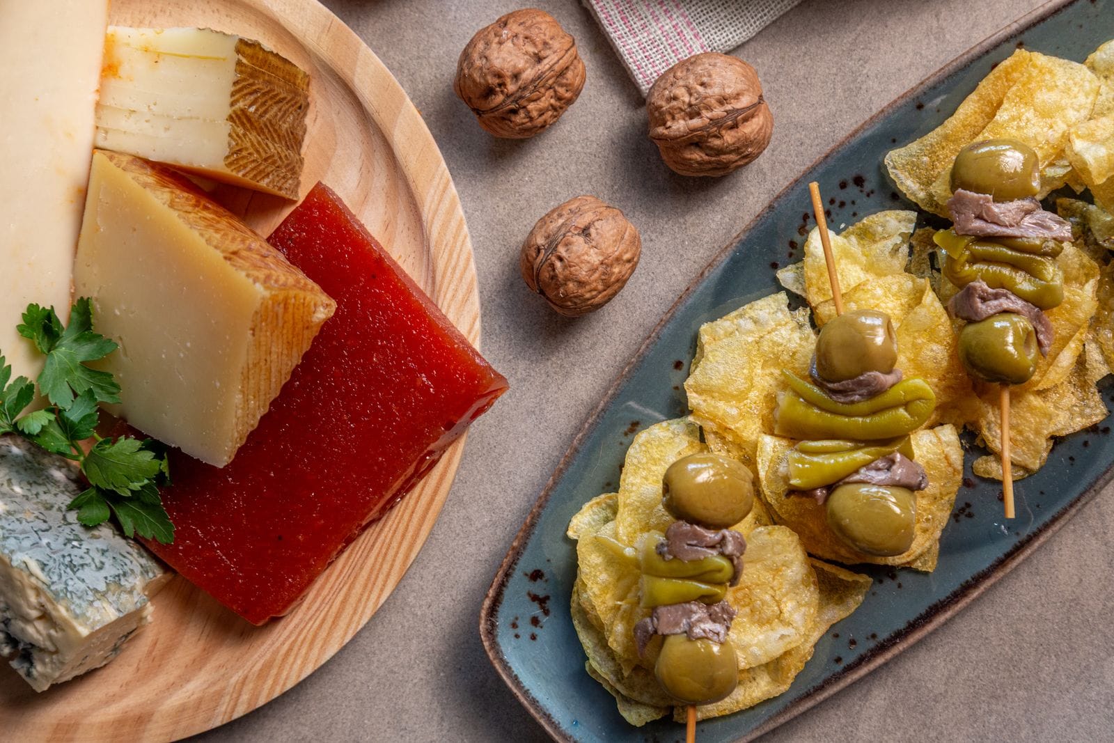 A traditional Mediterranean cheese and tapas platter with olives and cured meats