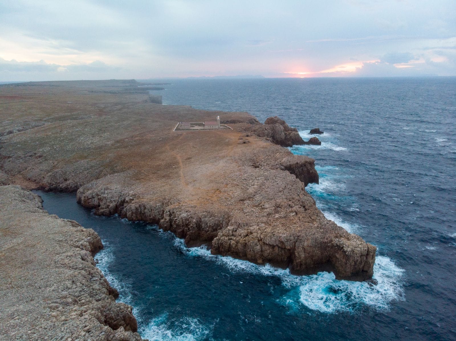 Aerial view of the rugged coastline near Ciutadella de Menorca at sunset