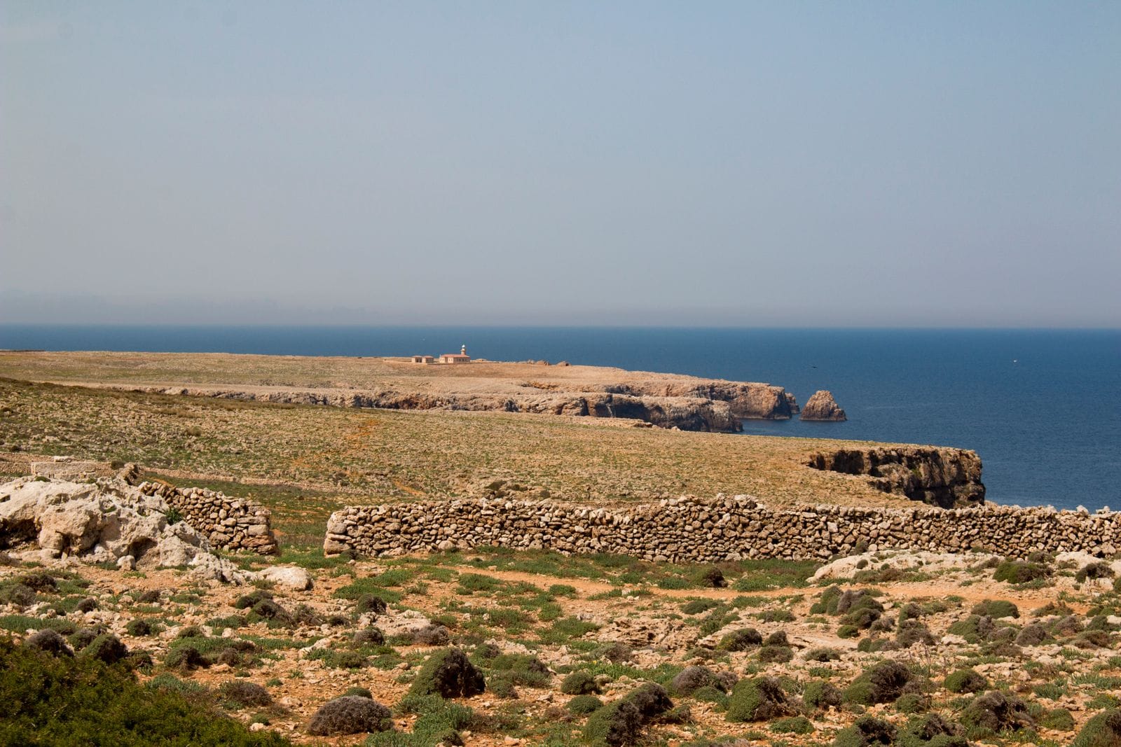 Rocky cliffs and turquoise sea along the coastline near Ciutadella de Menorca