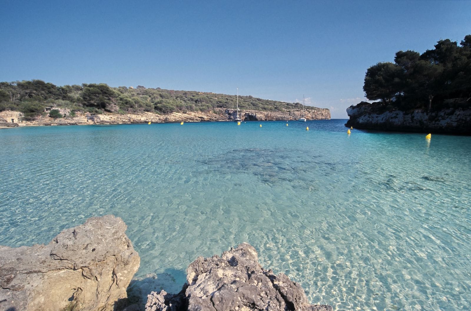 Clear turquoise water in a secluded cala cove on Menorca's south coast
