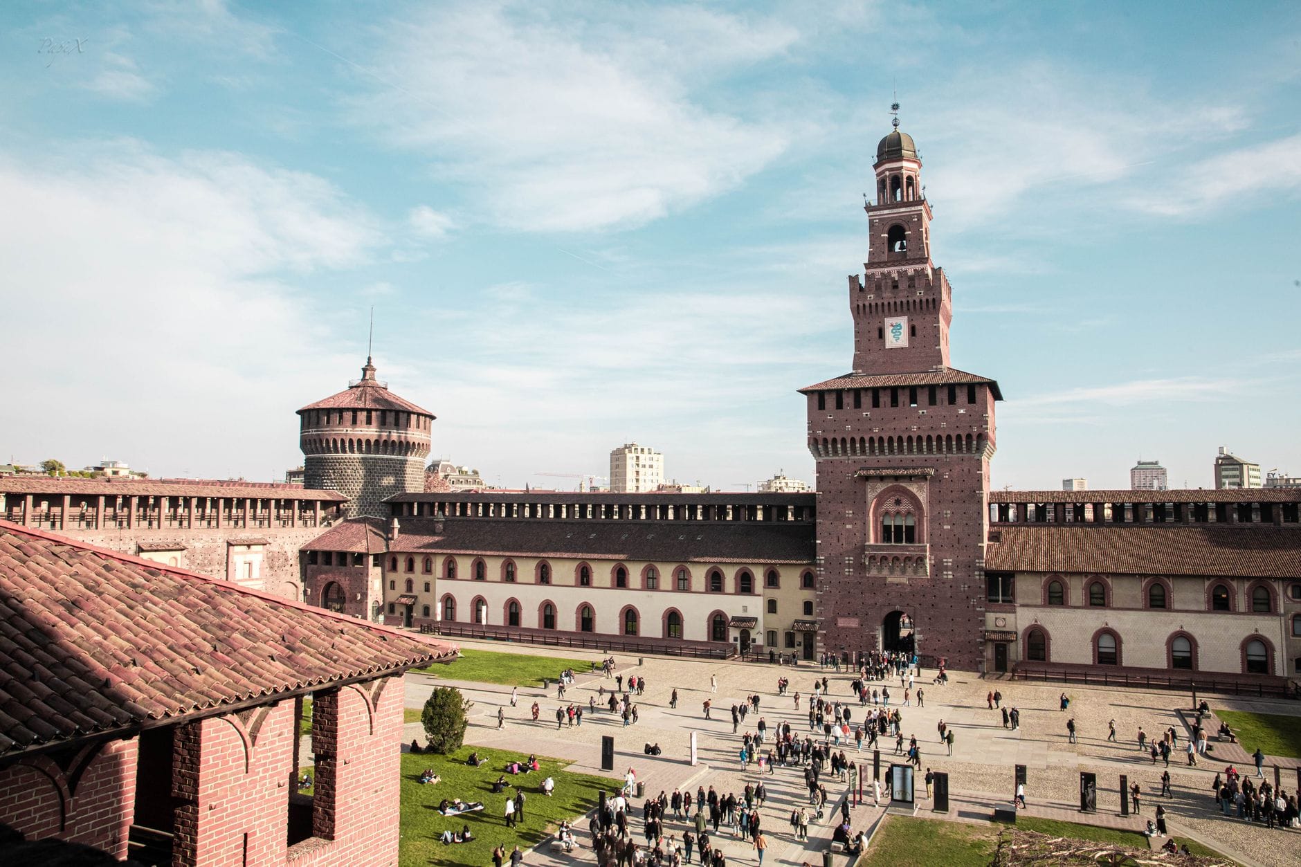 Aerial view of the courtyard inside Sforza Castle, Milan, with visitors walking across the open space