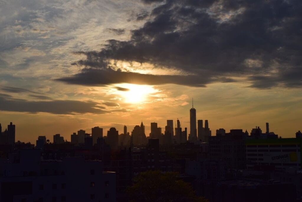 New York on a budget: the Manhattan skyline silhouetted against a vivid sunset