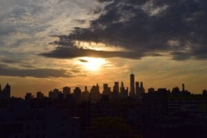 New York on a budget: the Manhattan skyline silhouetted against a vivid sunset