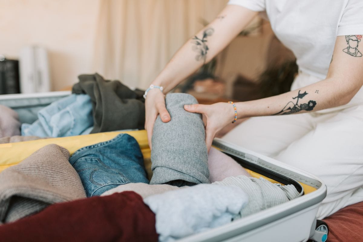 Rolling clothes to pack a carry-on bag efficiently for British Airways' cabin allowance