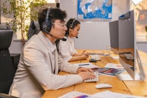 Customer service agents handling Ryanair complaints calls in a modern office