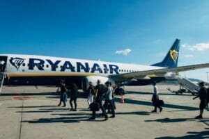 Travellers boarding a Ryanair aircraft under a clear blue sky: Ryanair Priority Boarding puts you in this queue first