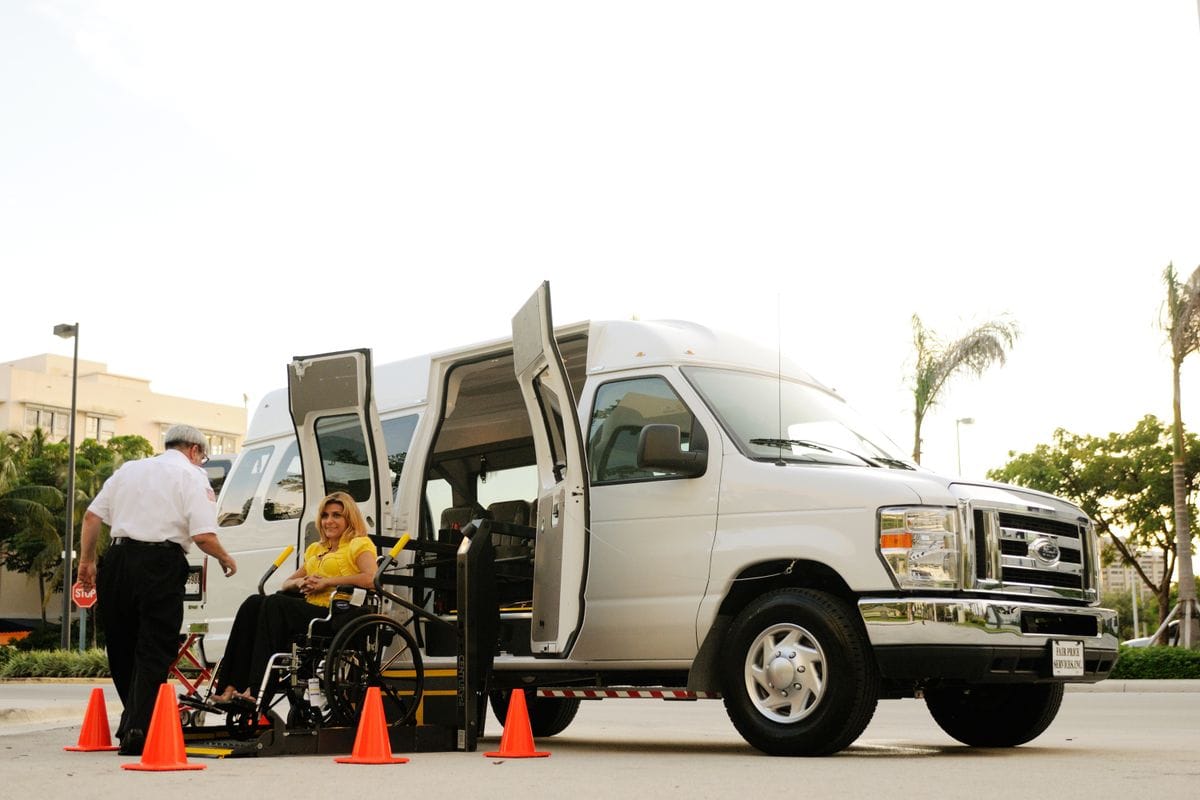 Ryanair special assistance: a wheelchair user boards an accessible vehicle lift assisted by a member of staff