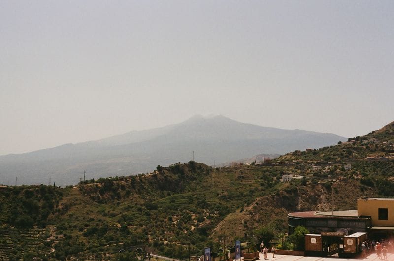 Mount Etna's summit seen hazily from a hillside terrace above Taormina, Sicily