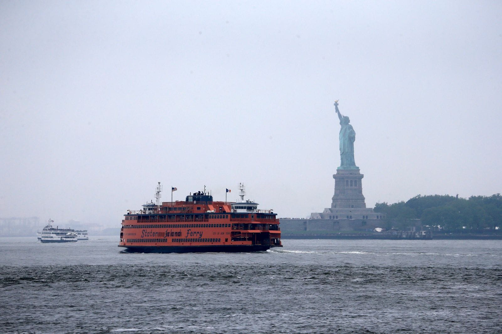 The Staten Island Ferry passing the Statue of Liberty
