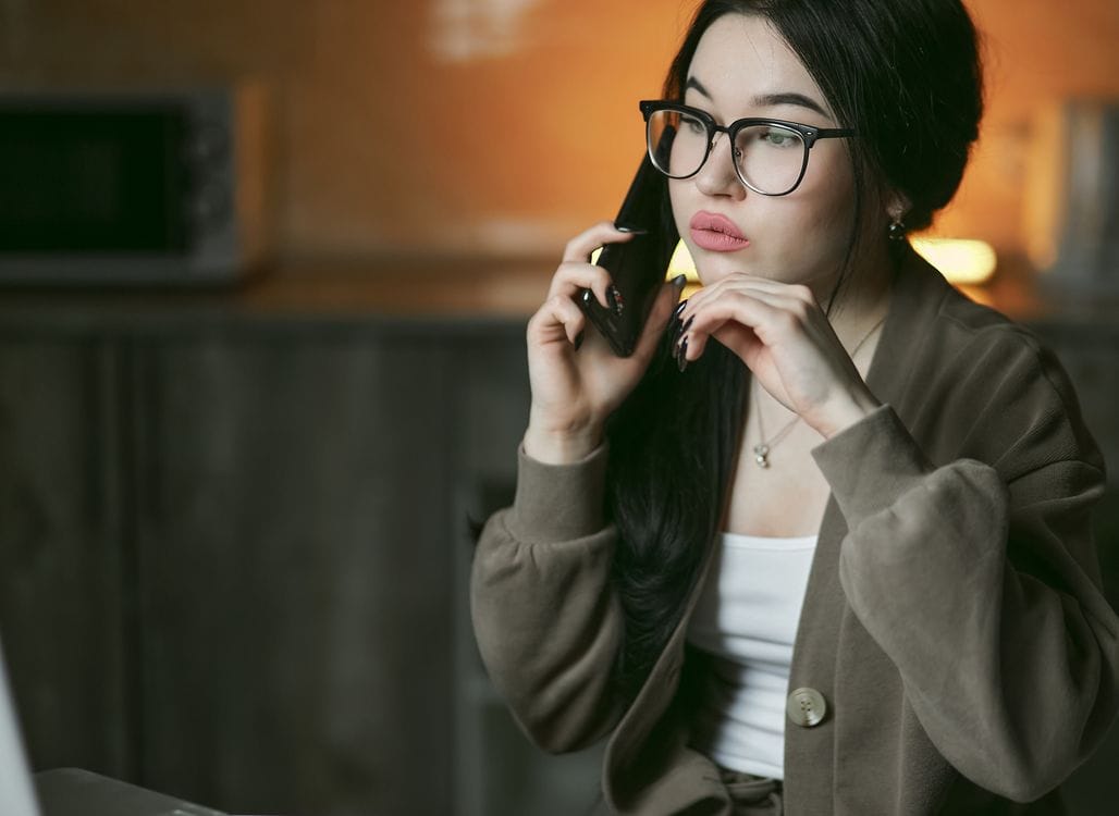 A woman on a phone call, the kind of conversation Staysure's quote tool requires before it will show a price